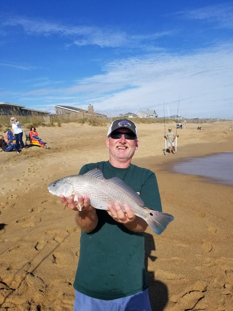 Bill with a red drum caught on surf OBX