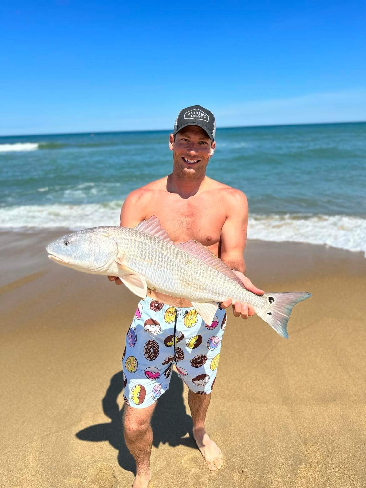 Picture of Tayler with another red drum on beach in Duck